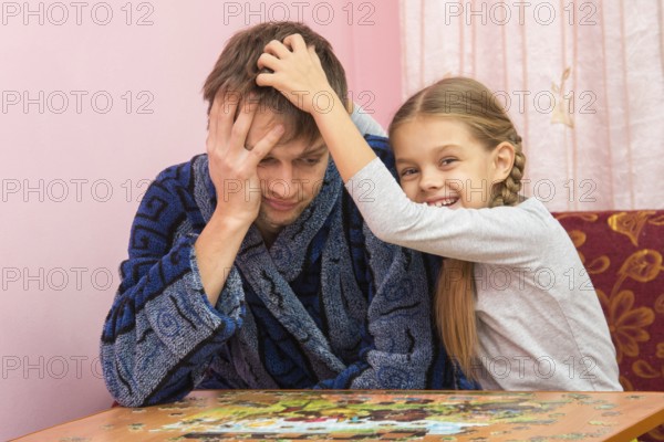 Daughter fun soothes tired dad who collect puzzles