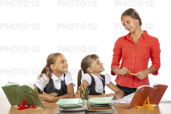 Girls at their desks have fun watching their beloved teacher
