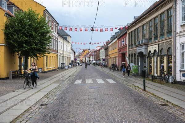 Koge, Seeland, Denmark, July 23, 2024 - Colorful historical houses at the main shopping street of the village, Europe