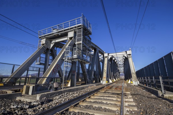 Modern railway steel bridge over highway