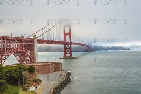 Aerial view of Golden Gate Bridge from Fort Point, south shore, symbol, icon and landmark of San Francisco, California, United States. Typical fog in summertime. Travel and holidays concept