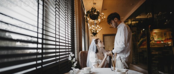 Bride and groom sharing a romantic moment by the window in a softly lit cafe