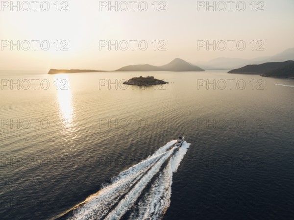 Motor boat sails to the Mamula fortress on the island. Kotor Bay.