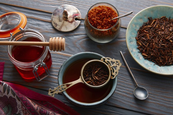 Kukicha tea served in bowl on wooden table board