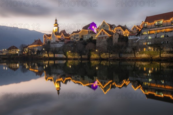 Christmas illuminated house facade of Frohnleiten reflected in the river Mur, Frohnleiten, Styria, Austria, Europe