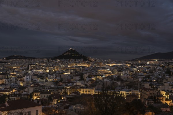 Athens Old Town, Attica, Greece, 12 28 2019 View over the Athens skyline and the Lycabettus hill during the blue hour, Europe