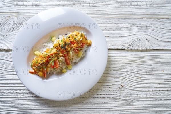 Seafood red curry with shrimps prawns sprouts and sesame seeds