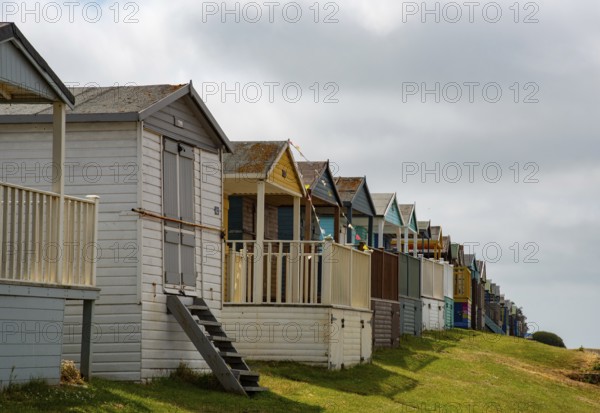 Colorful holiday beach huts. Vacations coastal wooden houses. Whitstable, Kent South East England