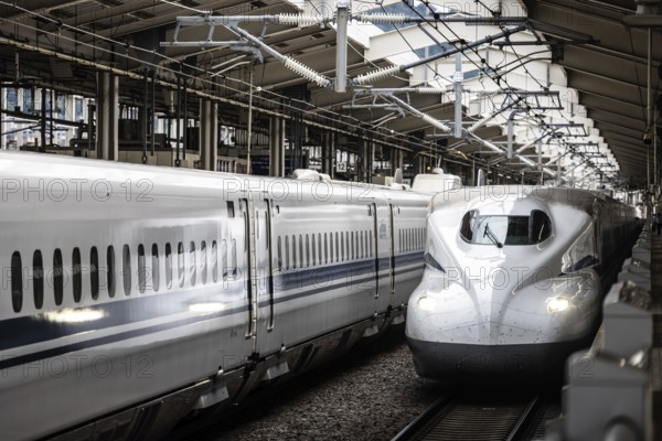 KYOTO, JAPAN - SEPTEMBER 24 2024: A Shinkansen high-speed bullet train arriving at Kyoto Station in Kyoto, Japan, Asia