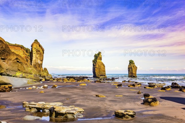 North Island. New Zealand. The Tongaporutu beach on the Pacific coast. Low tide exposed the coastal strip of the ocean. Magical journey to the ends of the world