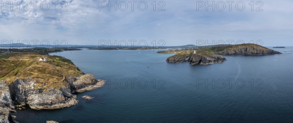 A panorama view of the entrance to the Baltimore Harbor in West Cork with teh Sherkin Island Lighthouse and the Baltimore Beacon