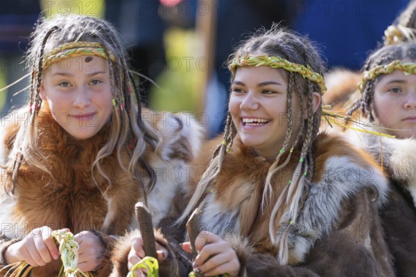 Two expression smiling girls in traditional clothing aboriginal of Kamchatka Peninsula. Itelmens national ritual festival of thanksgiving nature Alhalalalay. Kamchatka, Russian Far East, Sep 14, 2019