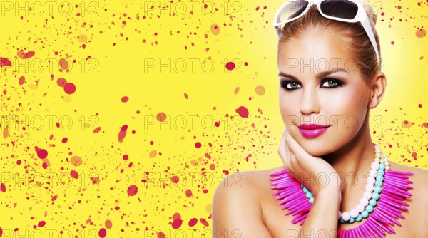 Beautiful woman with dark makeup and pink lipstick posing on yellow background wearing bright necklace and sunglasses, Toronto, Canada, North America
