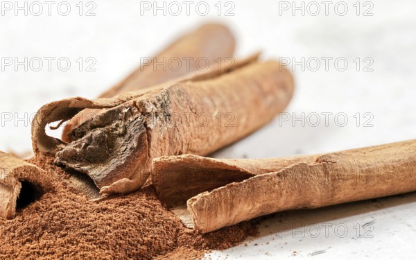 Closeup detail - Heap of cinnamon bark sticks on white stone like desk, Liptovsky Hradok, Slovakia, Europe