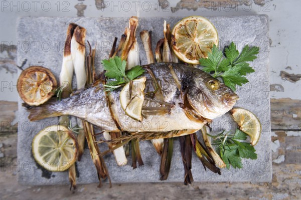 Presentation and preparation of a second dish of sea bream and onions