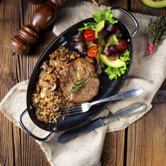 Pork steak with mushrooms and buckwheat groats and mango salad
