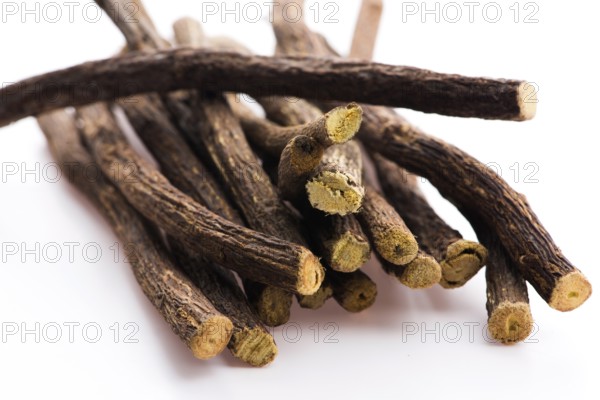 Licorice roots on white background