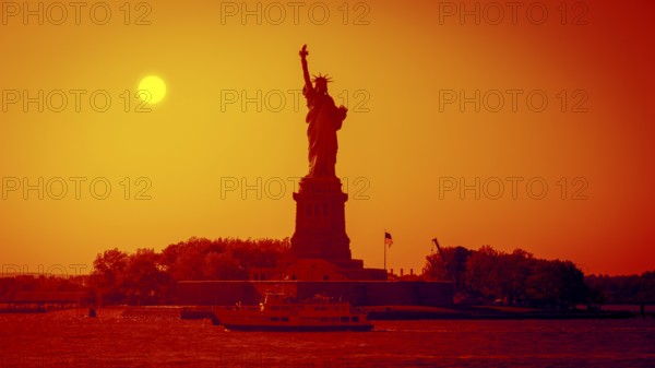 An image of the Liberty Statue at sunset