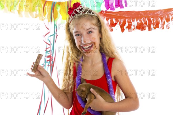 Happy party girl with puppy present eating chocolate in birthday dirty mouth