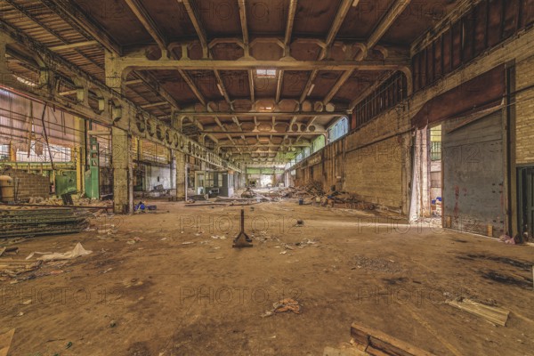 Wide, abandoned factory hall with debris on the floor and visible ceiling construction, The galvanising plant, Lost Place, Chaudfontaine, Province of Liège, Belgium, Europe