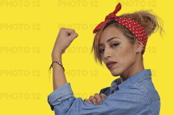 Beautiful woman dressed as the iconic Rosie the Riveter