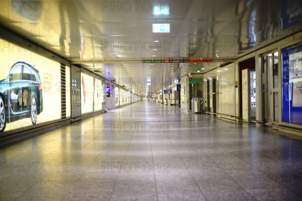 Frankfurt, Germany - November 25, 2016: An subway or connecting tunnel of individual airport terminals at Frankfurt Airport decorated with advertising posters on 25 November 2016 in Frankfurt