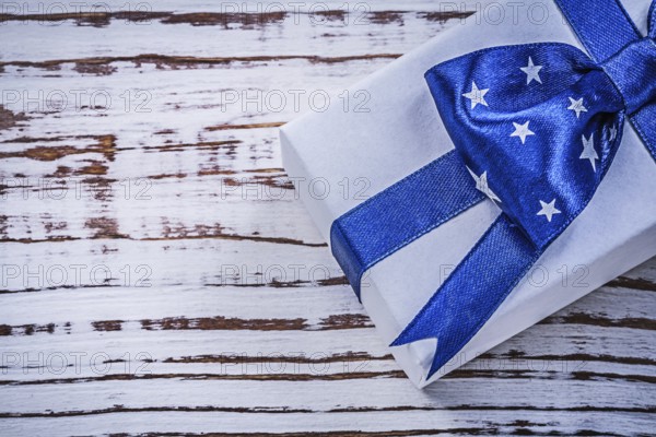 Wrapped present on vintage wooden board holidays concept