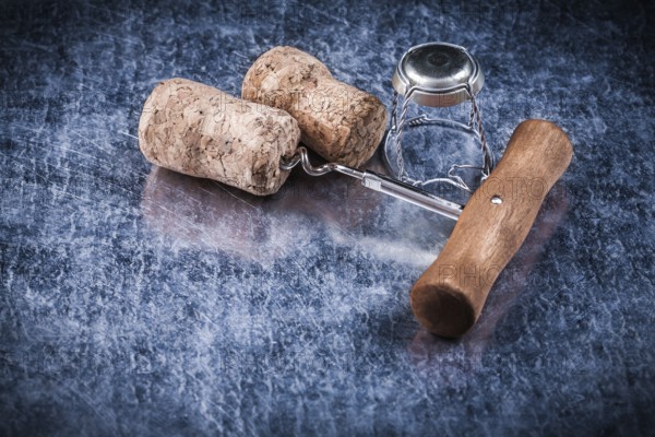 Champagne corks metal twisted wire corkscrew on metallic background