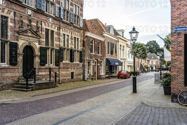 Naarden, Netherlands, August 5, 2016: Picturesque street in Naarden city centre. Naarden was developed into a fortified garrison town with a textile industry. It is an example of a star fort, complete with fortified walls and a moat