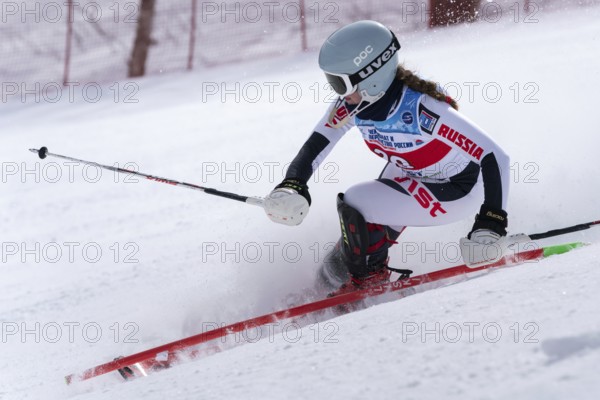 MOROZNAYA MOUNTAIN, KAMCHATKA PENINSULA, RUSSIA, MARCH 29, 2019: Russian Alpine Skiing Cup, International Ski Federation Championship, slalom. Mount skier Maria Bochina Moscow skiing down slope