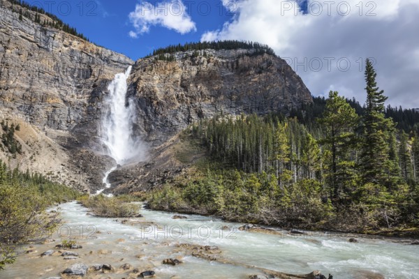 Rocky Mountains of Canada. Autumn Takakkaw Falls forms a full-flowing water flow of pearl color. Yoho National Park
