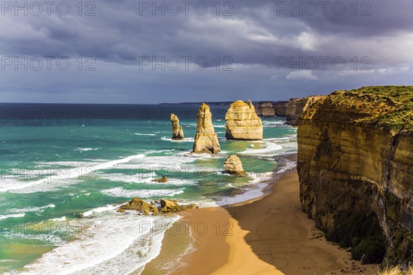 Magnificent morning light on the Pacific coast near Melbourne. Famous rocks Twelve Apostles in ocean waves surf. The concept of active and phototourism
