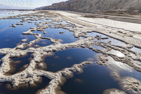 Dead Sea. The drainless salt lake in the Middle East, the saltiest lake in the world. On the surface of the water, the evaporated salt forms bizarre crystal shapes. Israel. The picture was taken by a drone from a aerial view