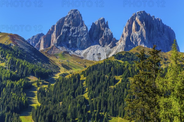 The coniferous forests at the foot of limestone and dolomite rocks. The most picturesque route in the Italian Dolomites, the Southern Limestone Alps. The concept of active and car tourism
