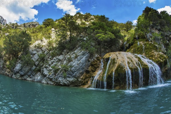 Scenic round waterfall in the side wall of the canyon Verdon. National park Merkantur, Provence, France. Photo taken fisheye lens