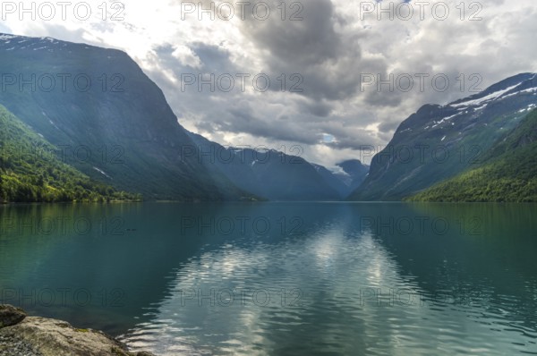The Kjenndalsbreen is part of the Jostedalsbreen, one of the largest glaciers in Norway, and forms an impressive mountain landscape with a beautiful lake in Sande. The glacier Kjenndalsbreen with a lake in Norway is a beautiful place to travel to in summertime