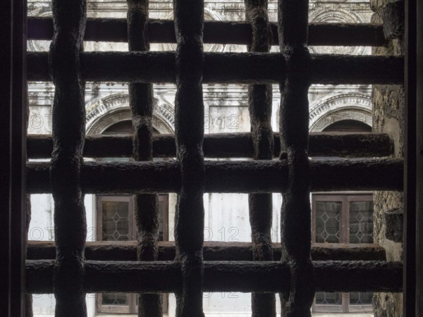 View trough iron grills of Circolo Artistico, the former prisons' building of the Doge's Palace, Venice, Veneto, Italy, Europe