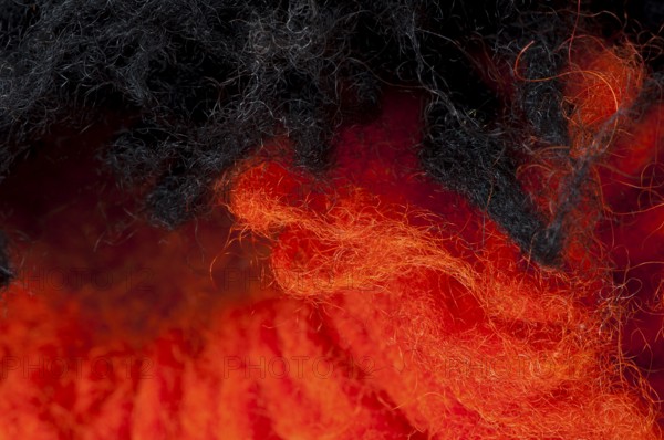 Black and red wool fibers closeup