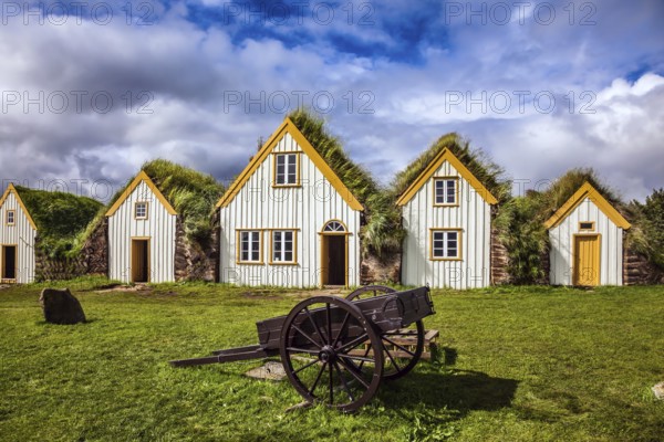 Facade of the farmhouse and ancient rural wheelbarrow. The concept of the historical and cultural tourism. Ethnographic Museum-estate Glaumbaer, Iceland, Europe