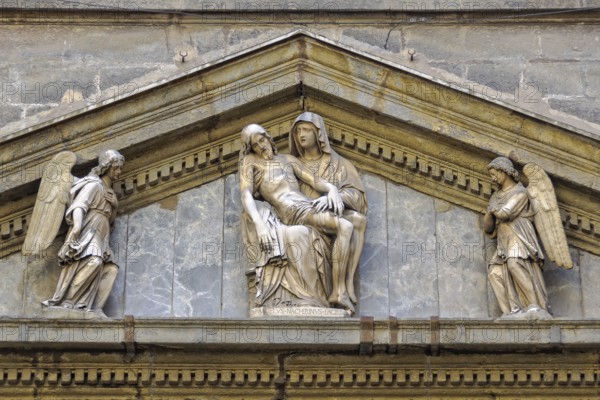 Sculpture of La Pieta by Michelangelo Naccherino in the tympanum above the entrance of the Chapel of Monte di Pieta, Naples, Campania, Italy, Europe