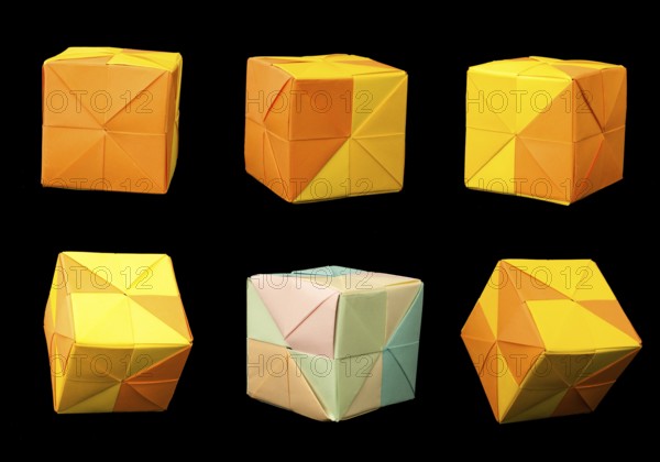 Paper made multi colored patterned cubes folded origami style. Yellow and orange colors