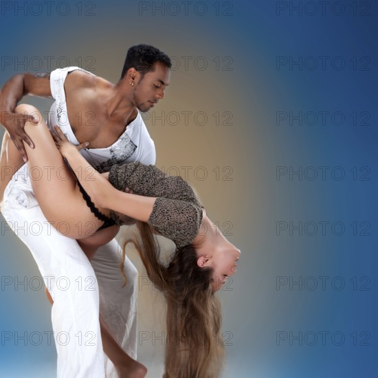 Sensual couple performing an artistic and emotional contemporary dance Caribbean Salsa