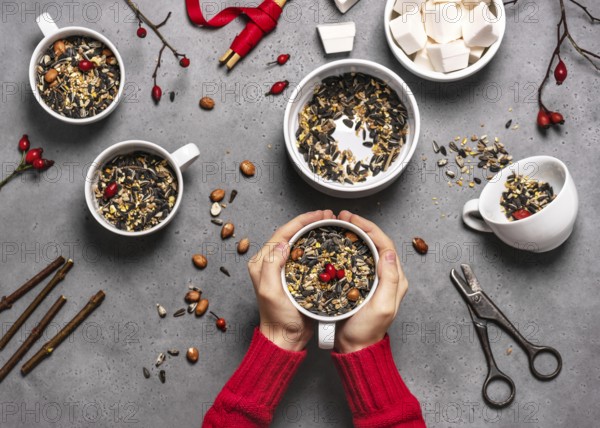 Step 2: All the cups are filled with bird seed and rosehip berries. Making feeding cups. Handicrafts with children. Step by step instructions. Animal welfare concept