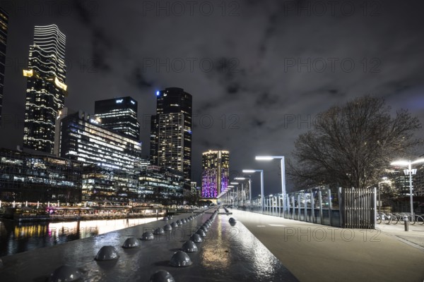 MELBOURNE, AUSTRALIA - JULY 5, 2024: Melbourne skyline as seen at dusk from Sandridge Bridge near Southbank in Melbourne, Victoria, Australia, Oceania