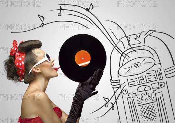Vintage photo of a retro pinup girl licking retro records with her tongue against the sketchy background of a Wurlitzer jukebox