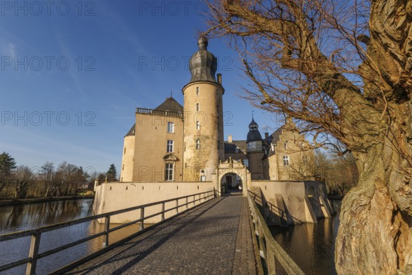 Impressive castle with bridge and tower in sunny surroundings, gemen, münsterland, germany
