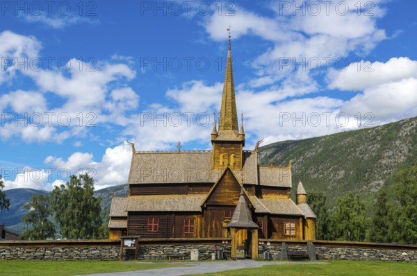 The famouse historic wooden church in Lom in Norway with blue sky summertime