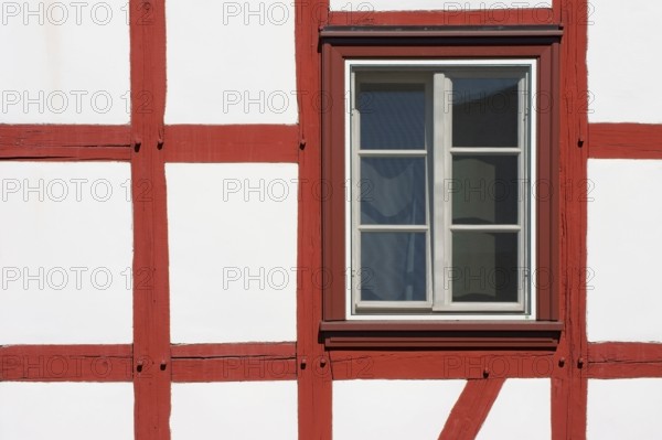 Close-up of the beam construction of a half-timbered house with windows