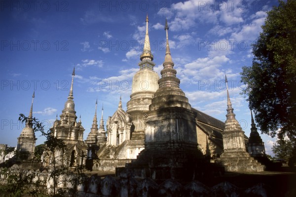 Wat Suan Dok (Thai: ?????????, which roughly translates as Flower Garden Temple) was founded by King Kue Na of Lanna for the monk Sumana Thera in the year 1370 CE. The temple was built in the centre of Wiang Suan Dok, a walled settlement of the Lawa people older than Chiang Mai itself.<br/><br/> Chiang Mai, sometimes written as 'Chiengmai' or 'Chiangmai', is the largest and most culturally significant city in northern Thailand, and is the capital of Chiang Mai Province. It is located 700 km (435 mi) north of Bangkok, among the highest mountains in the country. The city is on the Ping river, a major tributary of the Chao Phraya river.<br/><br/> King Mengrai founded the city of Chiang Mai (meaning 'new city') in 1296, and it succeeded Chiang Rai as capital of the Lanna kingdom. The ruler was known as the Chao. The city was surrounded by a moat and a defensive wall, since nearby Burma was a constant threat.<br/><br/> Chiang Mai formally became part of Siam in 1774 by an agreement with Cha...