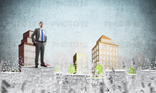 Confident businessman in suit standing on pile of documents among flying letters with drawn cityscape background. Mixed media